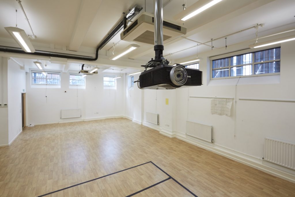 An empty room with a ceiling projector