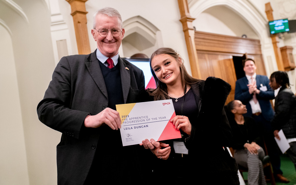 Two individuals holding an award certificate for "Pre-Apprentice Progression of the Year."