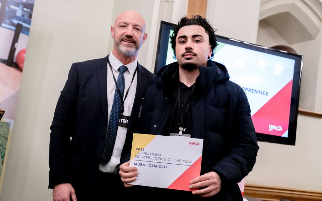 Two individuals holding an award for "Inspirational Apprentice of the Year."