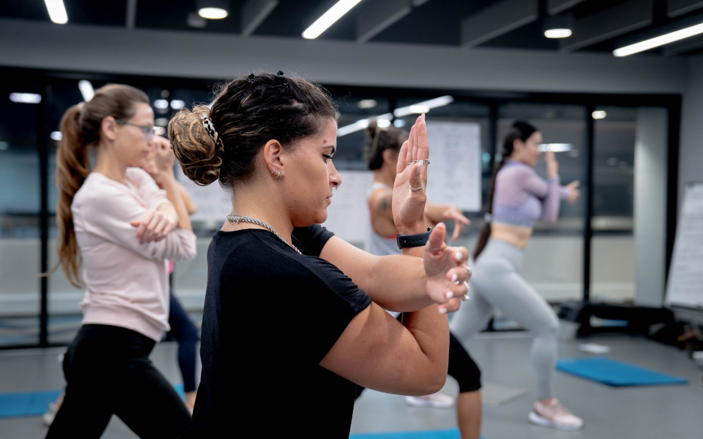 Group of people participating in a fitness class at a gym.