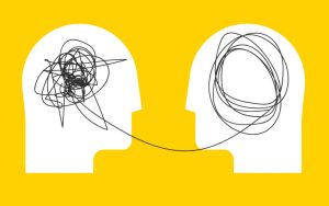 Two silhouetted heads against yellow with tangled and untangled lines inside, connected by a single line.